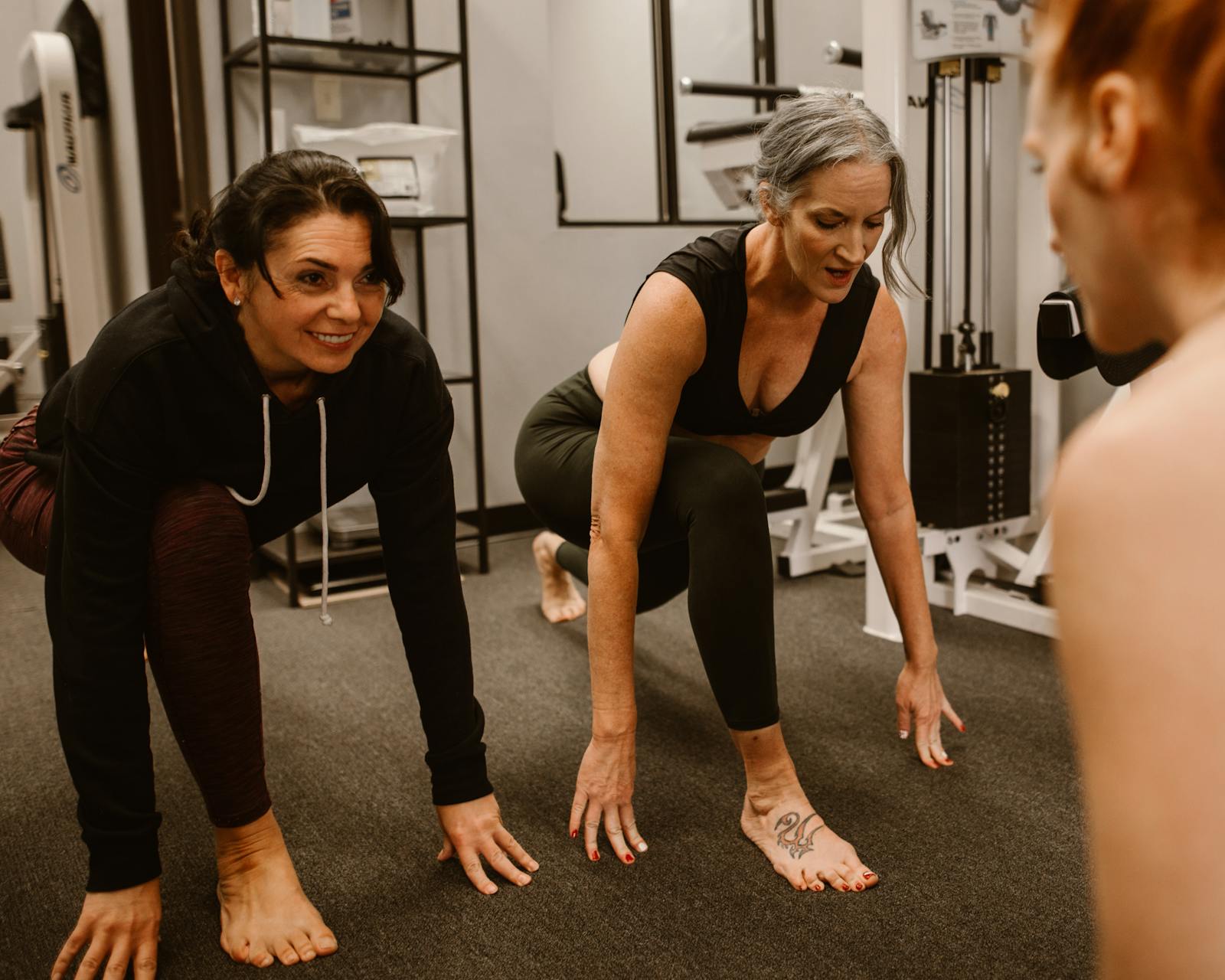Adult in a bright boutique fitness studio with kids in a class nearby